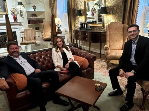 Three guests seated in an elegant sitting room