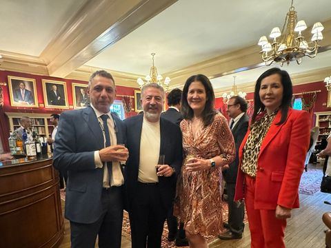 Four guests with drinks at a reception