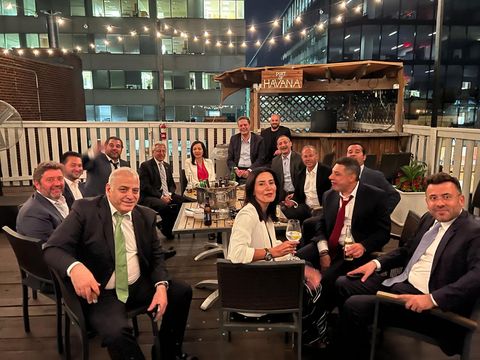 Group gathered on a rooftop terrace at night