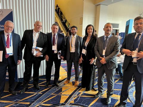 Seven delegates with name badges at the SelectUSA summit