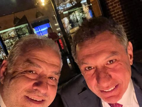 Two men taking a selfie at an evening venue