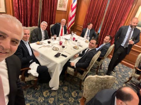Guests seated around a table, selfie view